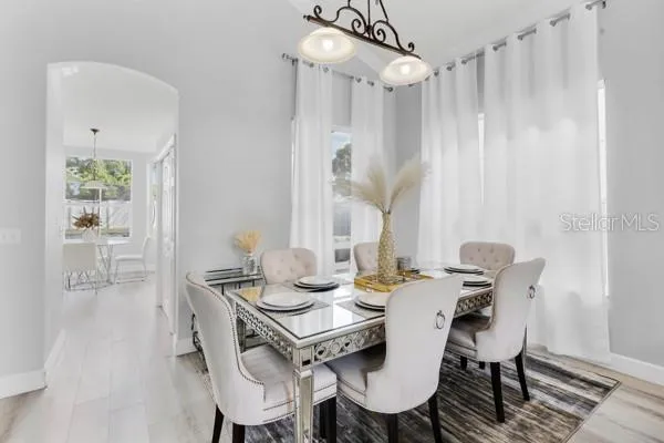 a view of a dining room with furniture and wooden floor