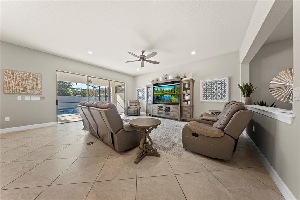 7905 Wandering Way Orlando, FL 32836 - Photo 13 of 70 a living room with furniture and a floor to ceiling window