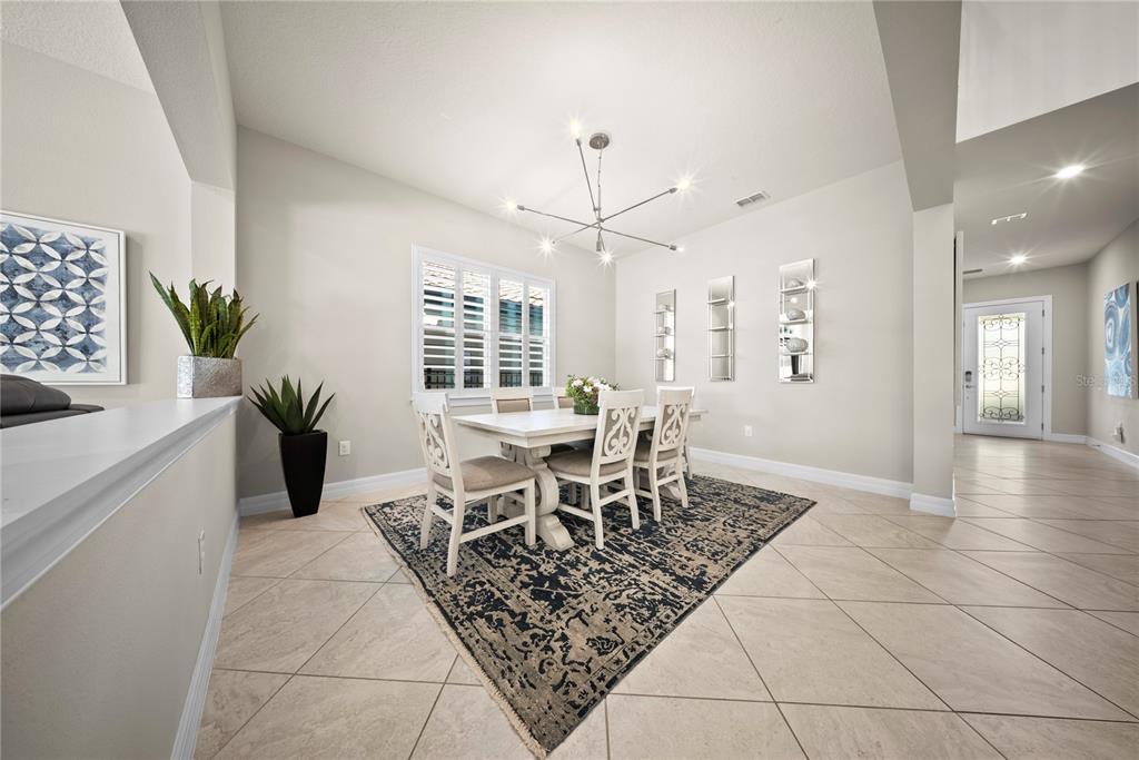 7905 Wandering Way Orlando, FL 32836 - Photo 21 of 70 a dining room with furniture and a floor to ceiling window