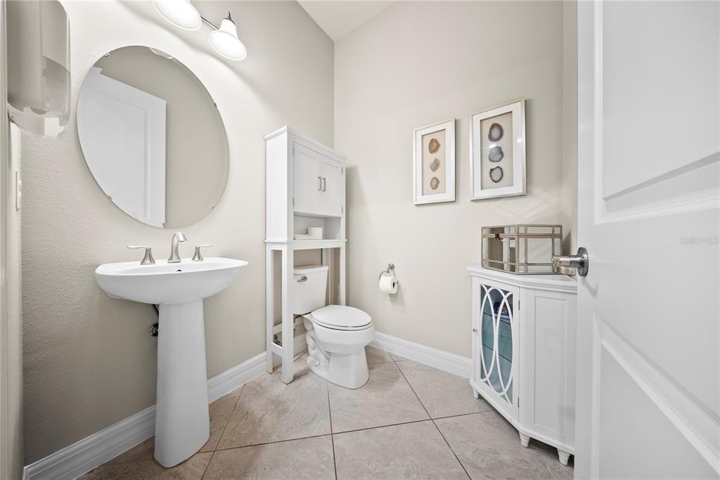 7905 Wandering Way Orlando, FL 32836 - Photo 24 of 70 a bathroom with a toilet sink and mirror