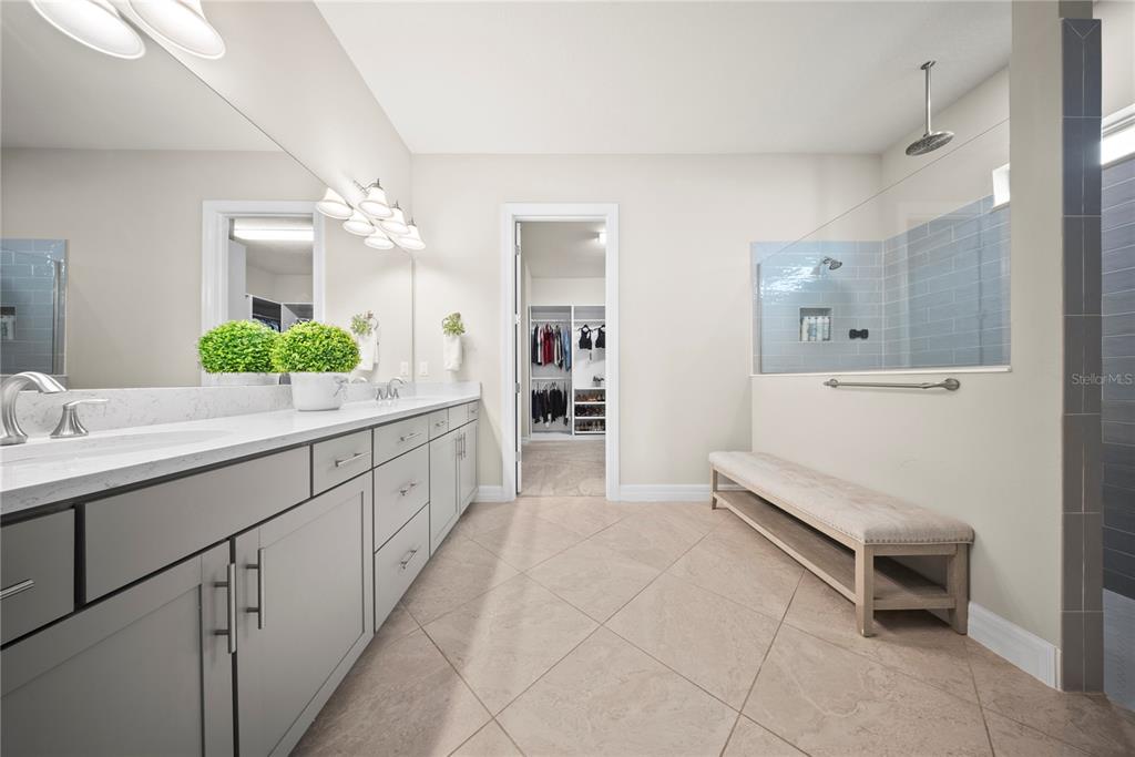 7905 Wandering Way Orlando, FL 32836 - Photo 28 of 70 a spacious en suite bathroom with a double vanity sink and a mirror