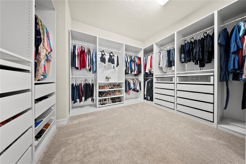 7905 Wandering Way Orlando, FL 32836 - Photo 32 of 70 a view of walk in closet with clothes and shoes