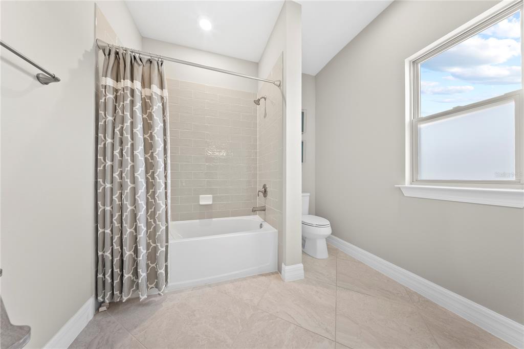 7905 Wandering Way Orlando, FL 32836 - Photo 43 of 70 a bathroom with a bathtub and a shower