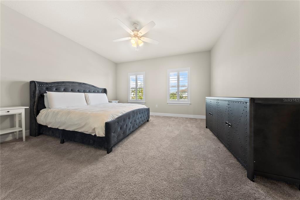 7905 Wandering Way Orlando, FL 32836 - Photo 44 of 70 a spacious bedroom with a bed and window