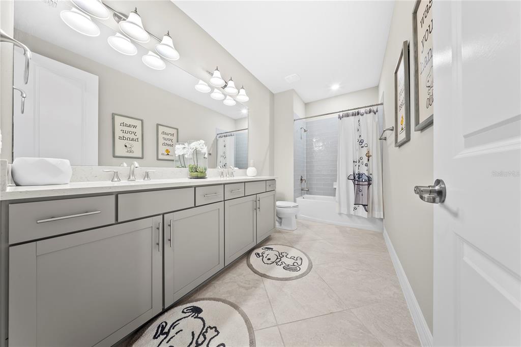 7905 Wandering Way Orlando, FL 32836 - Photo 47 of 70 a bathroom with a sink a vanity and a mirror