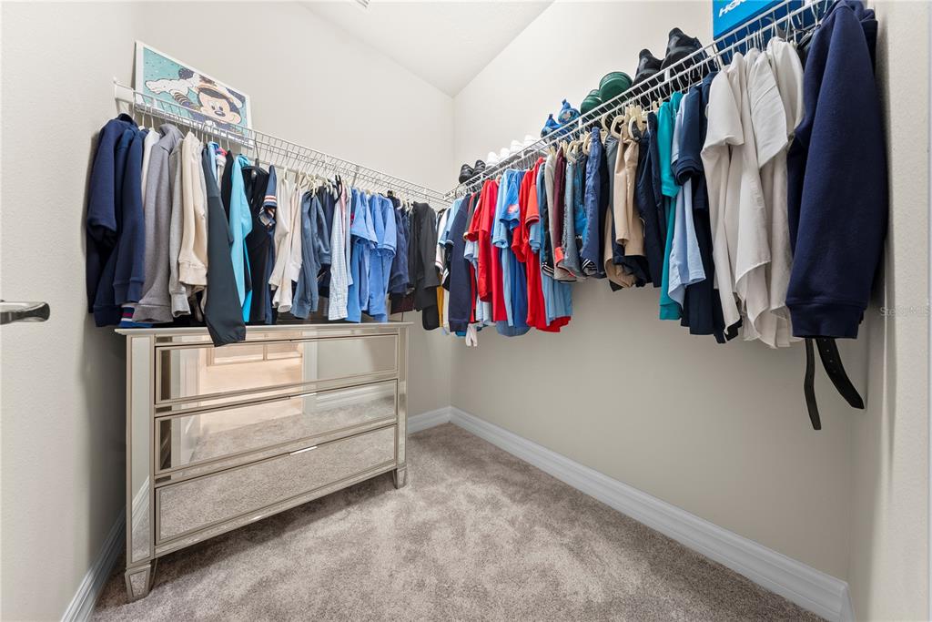 7905 Wandering Way Orlando, FL 32836 - Photo 55 of 70 a view of walk in closet with clothes