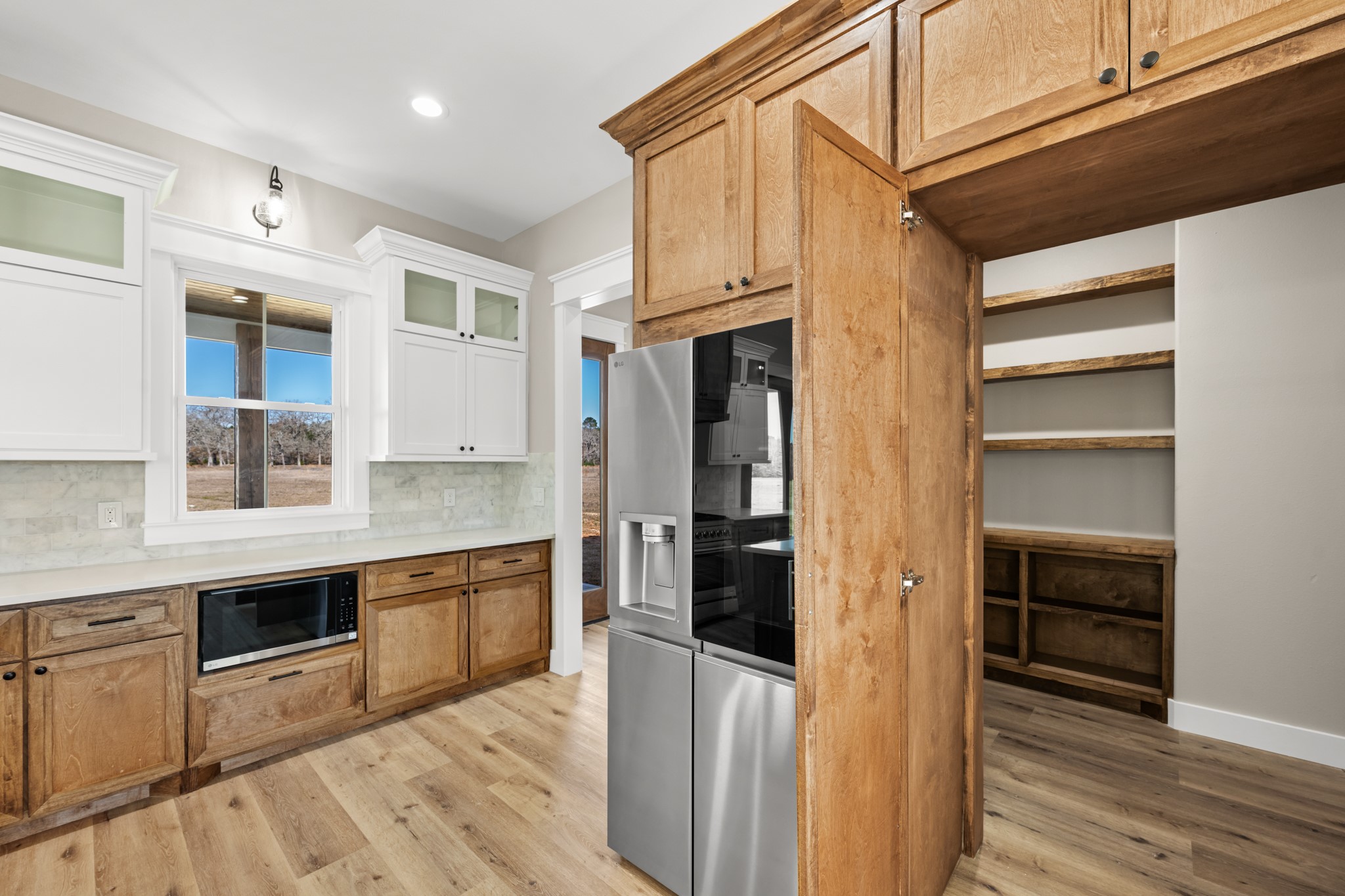 95 Longhorn Loop New Waverly, TX 77358 - Photo 12 of 50 a kitchen with stainless steel appliances granite countertop a refrigerator and a sink