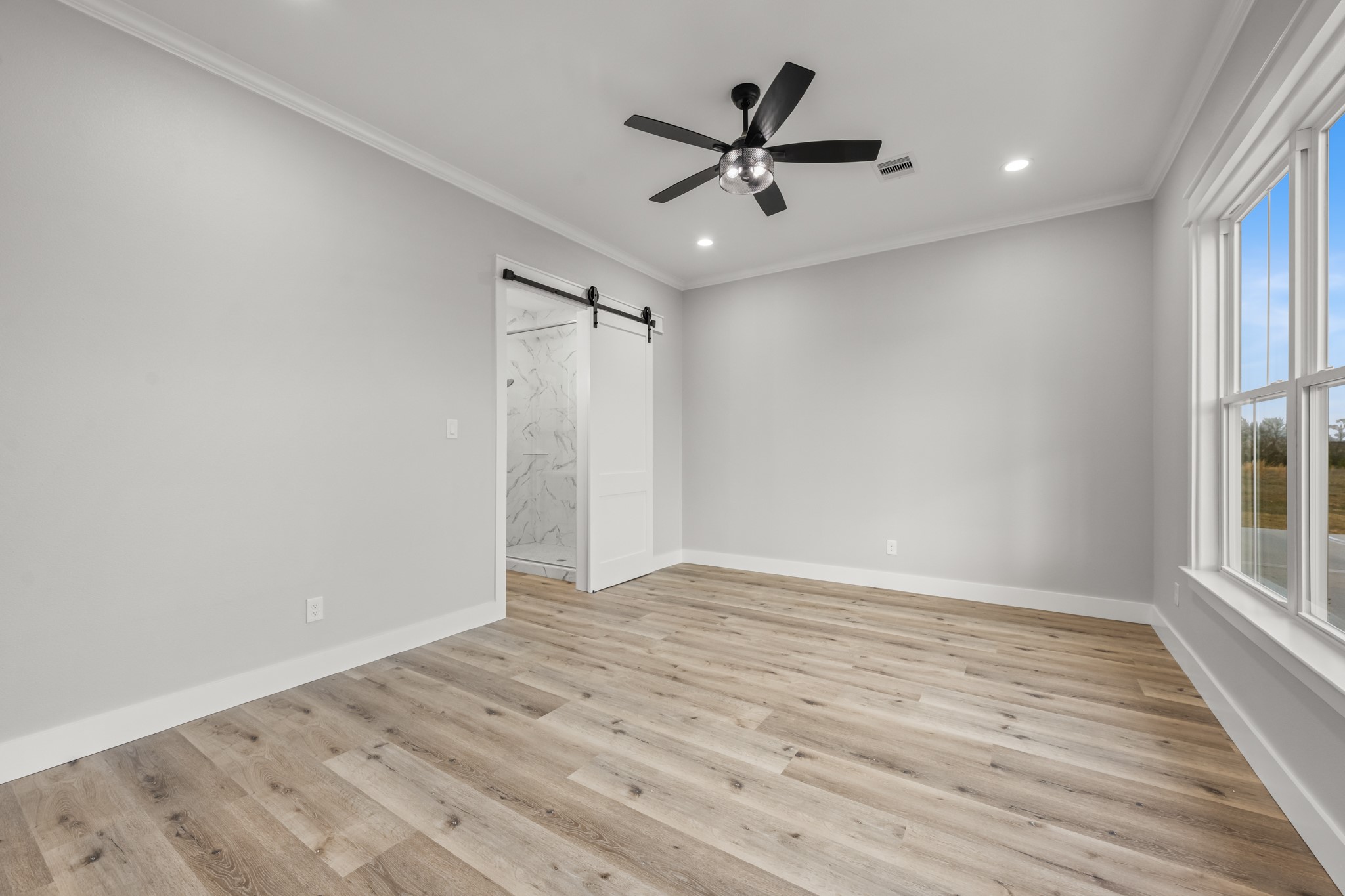 95 Longhorn Loop New Waverly, TX 77358 - Photo 25 of 50 wooden floor in an empty room with a window