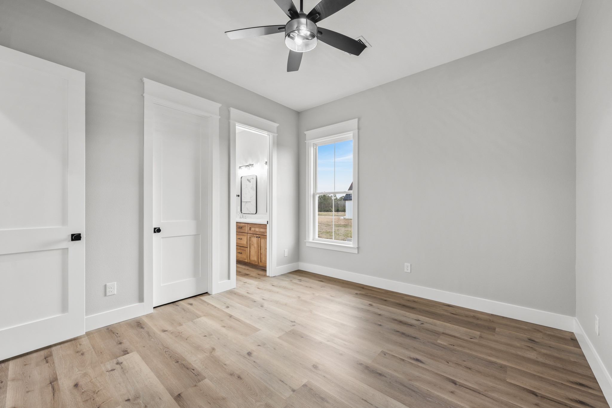 95 Longhorn Loop New Waverly, TX 77358 - Photo 29 of 50 a view of an empty room with wooden floor and a window