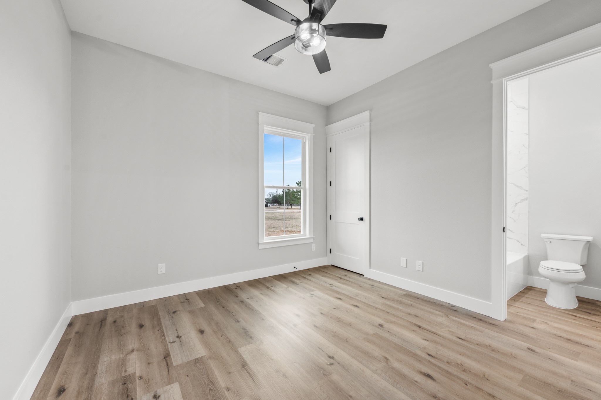 95 Longhorn Loop New Waverly, TX 77358 - Photo 31 of 50 a view of an empty room with wooden floor and a window