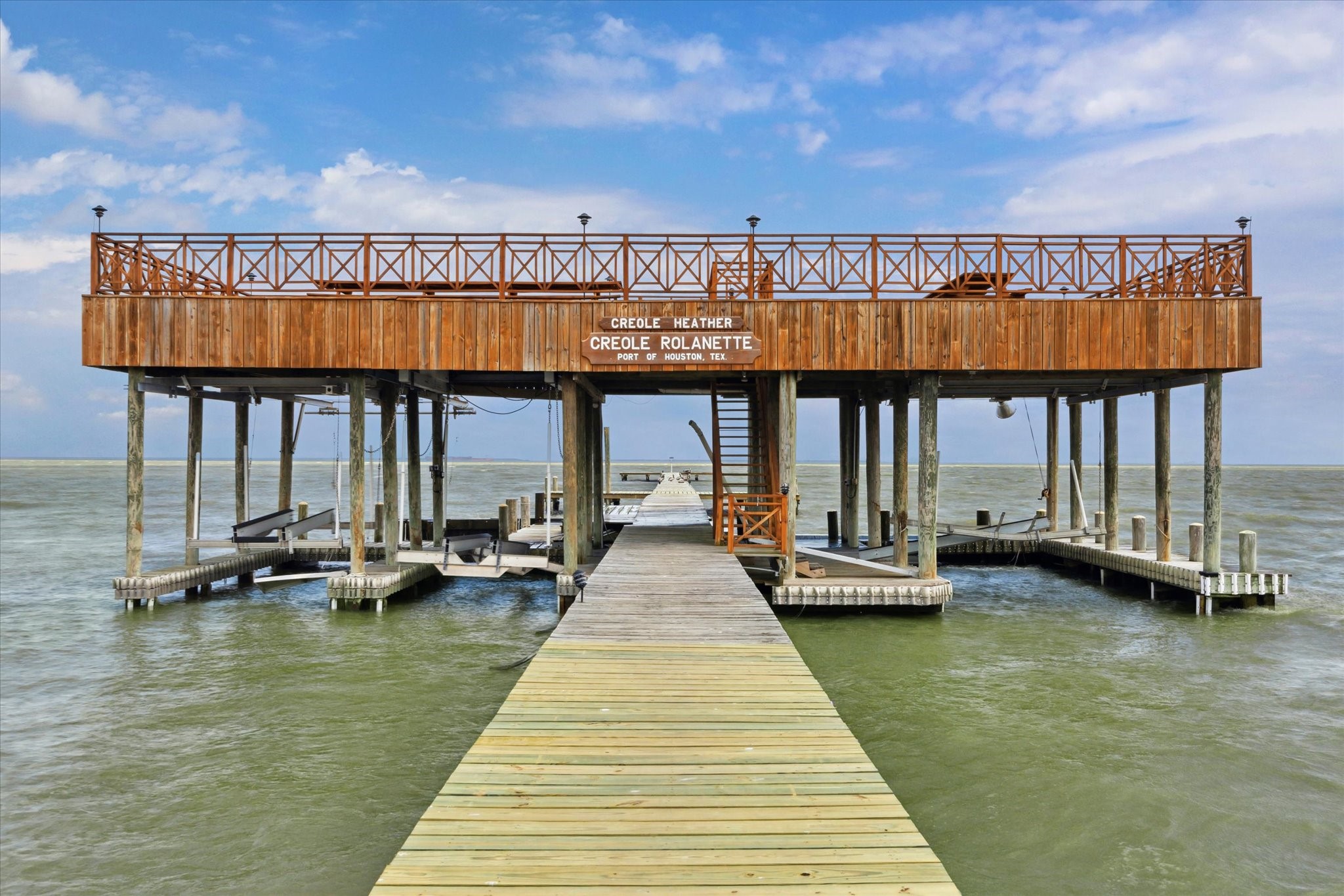 102 South R Street La Porte, TX 77571 - Photo 6 of 43 Another view of one of two of the piers, featuring raised observation, dining and entertaining deck above multiple boat slips.