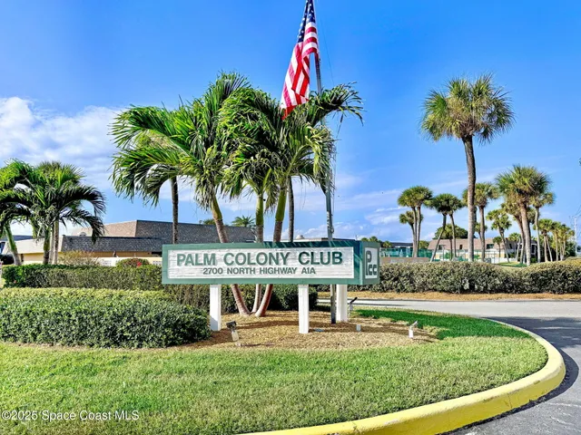 a view of a house with a yard and potted plants