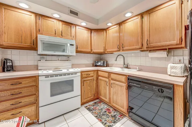a kitchen with granite countertop cabinets stainless steel appliances and a sink