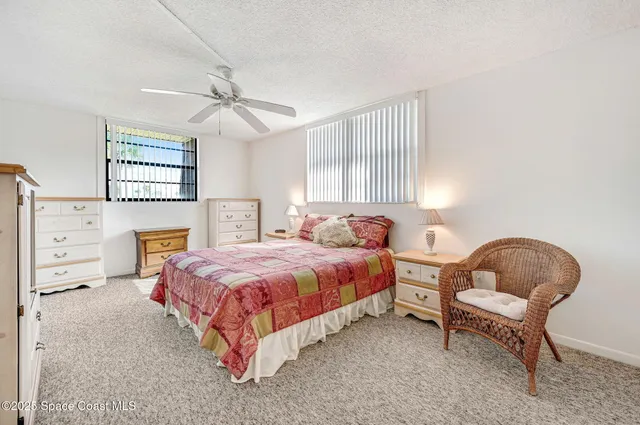 a bed room with a bed and a chair