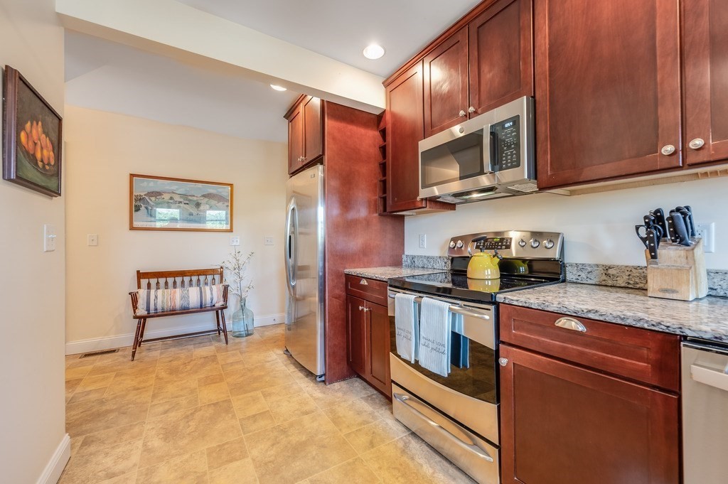 55 Paul Street Watertown, MA 02472 - Photo 11 of 42 a kitchen with stainless steel appliances granite countertop a stove microwave and sink