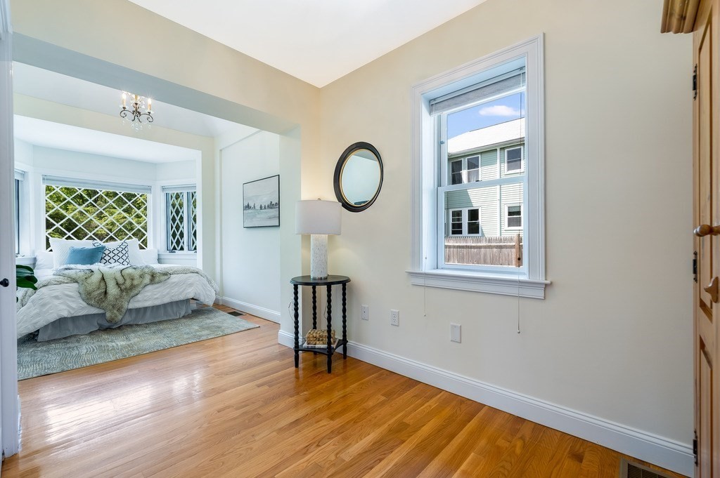 55 Paul Street Watertown, MA 02472 - Photo 19 of 42 a view of an empty room with wooden floor and a window