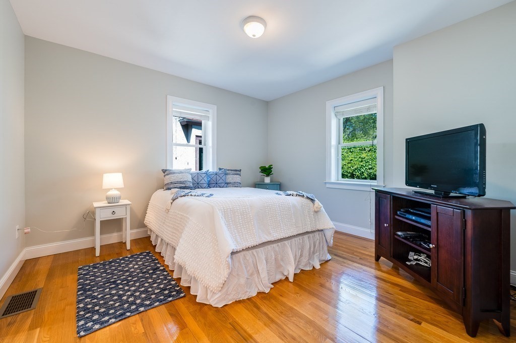 55 Paul Street Watertown, MA 02472 - Photo 24 of 42 a bedroom with a bed and a flat screen tv