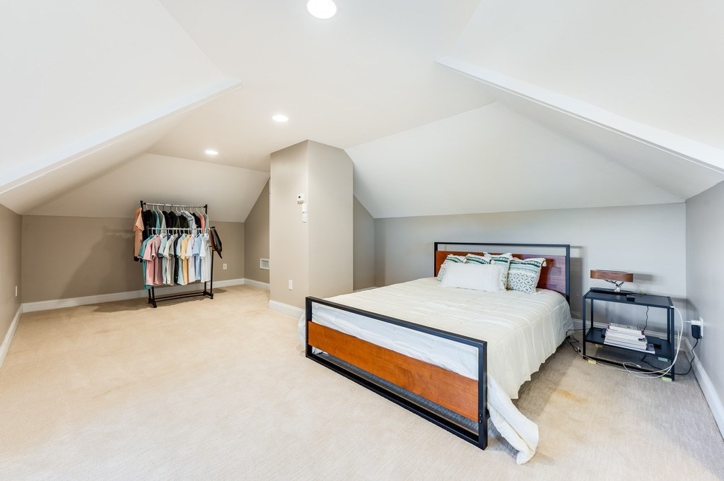 55 Paul Street Watertown, MA 02472 - Photo 26 of 42 a bedroom with a bed and a lamp on table