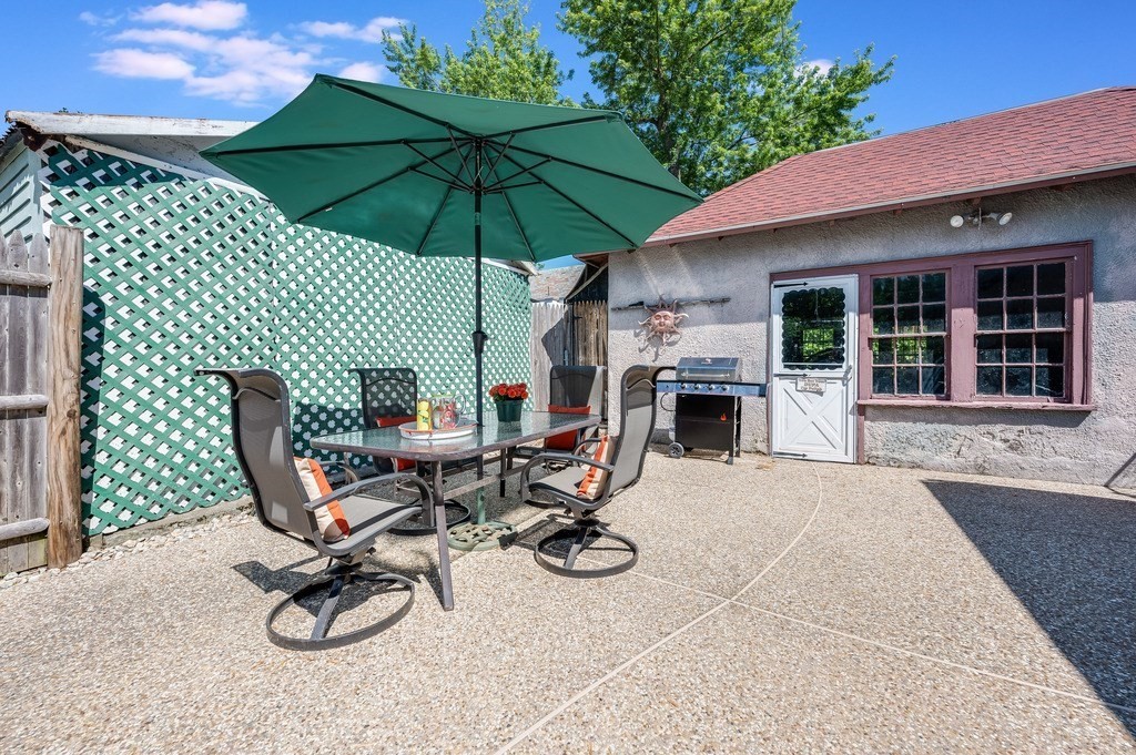 55 Paul Street Watertown, MA 02472 - Photo 35 of 42 a view of a backyard with furniture and a fireplace