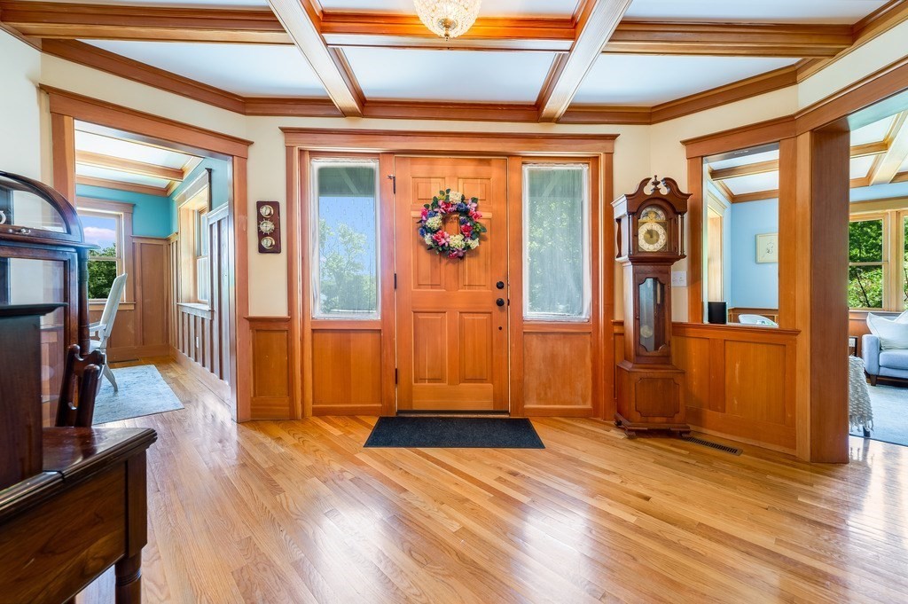 55 Paul Street Watertown, MA 02472 - Photo 5 of 42 a view of a hallway with wooden floor and front door