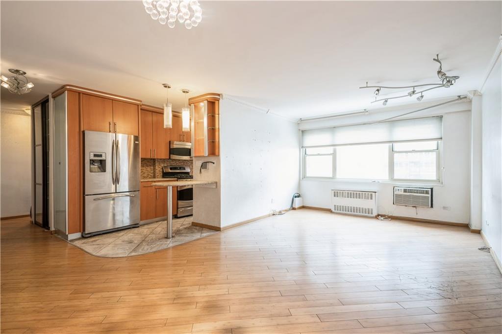 2944 West 5th Street, Unit 14F Brooklyn, NY 11224 - Photo 2 of 13 a view of a kitchen with a sink dishwasher refrigerator stove and a large window