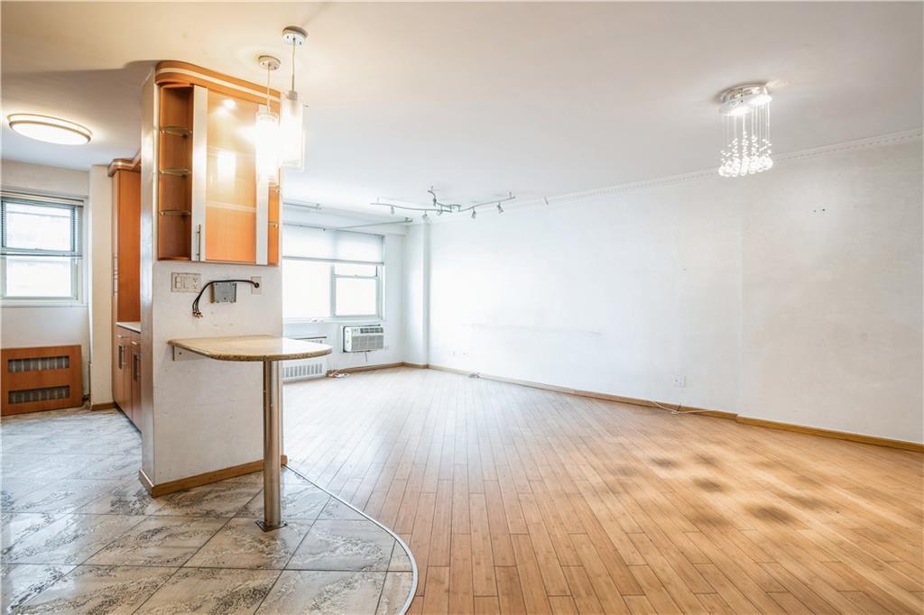 2944 West 5th Street, Unit 14F Brooklyn, NY 11224 - Photo 4 of 13 a view of a kitchen with a sink hardwood floor and a living room