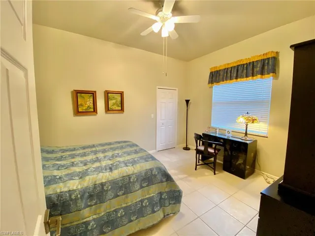 a bedroom with a bed and a table in it