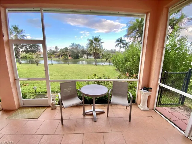 a view of a chairs and table in patio with a yard