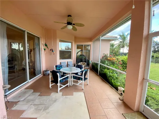 a dining room with wooden floor and a potted plant