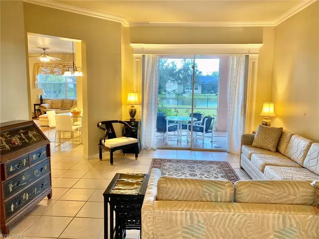 a living room with furniture and a floor to ceiling window