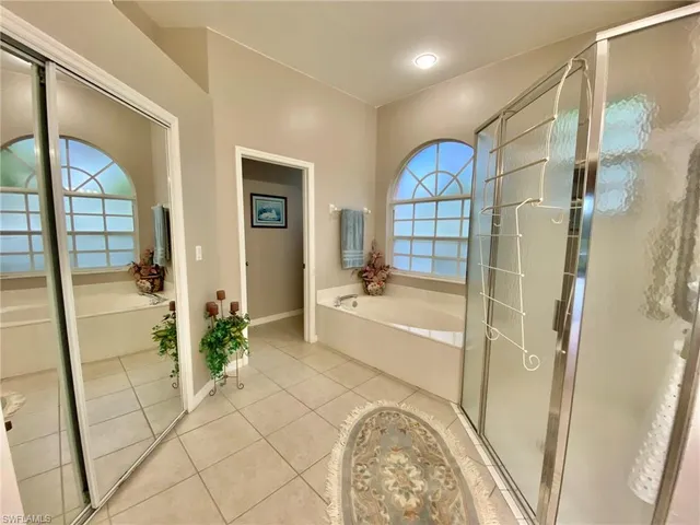 a view of a bathroom with tub and door