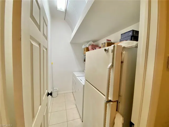 a white refrigerator freezer sitting inside of a kitchen