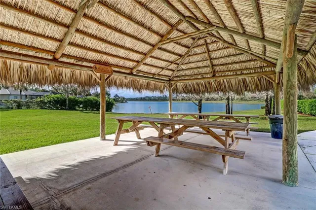 a view of a patio with a table and chairs under an umbrella