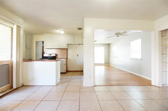 a view of a kitchen with a stove cabinets and a kitchen