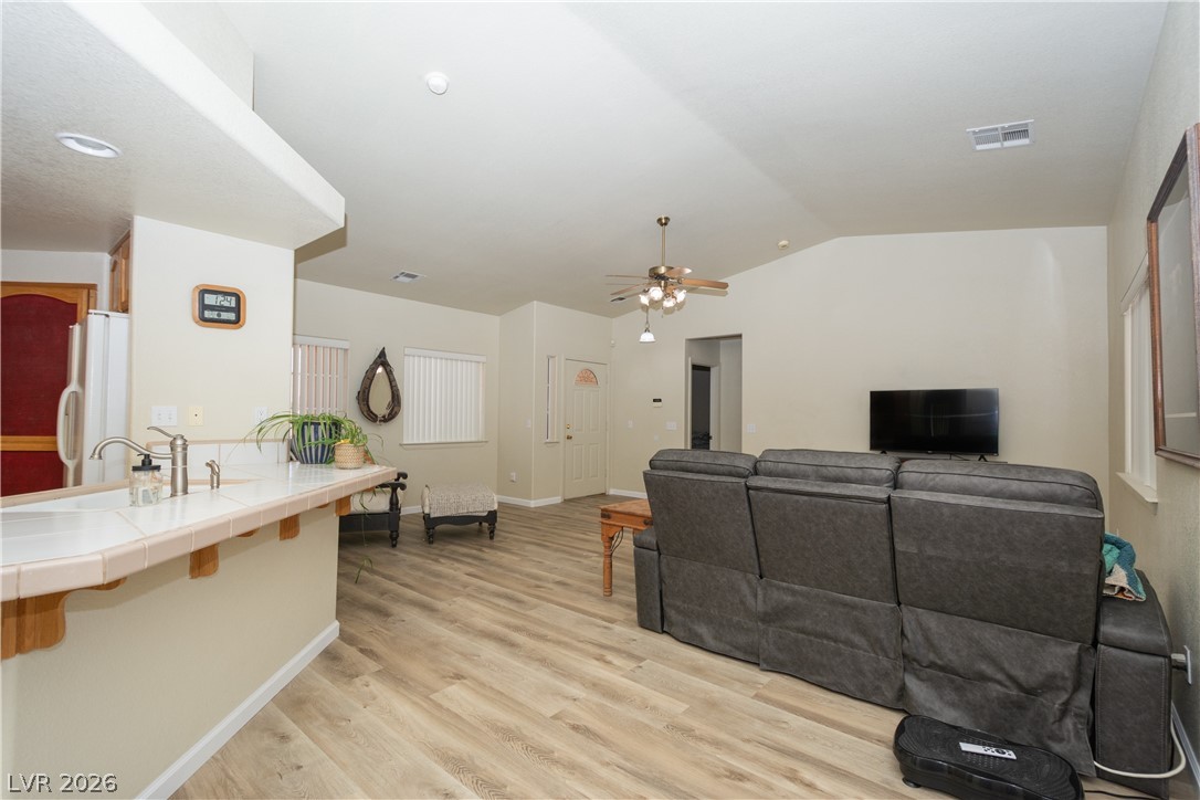 2381 Tough Boy Road Pahrump, NV 89060 - Photo 7 of 44 This living space seamlessly connects to the kitchen, offering an open and airy layout with vaulted ceilings.