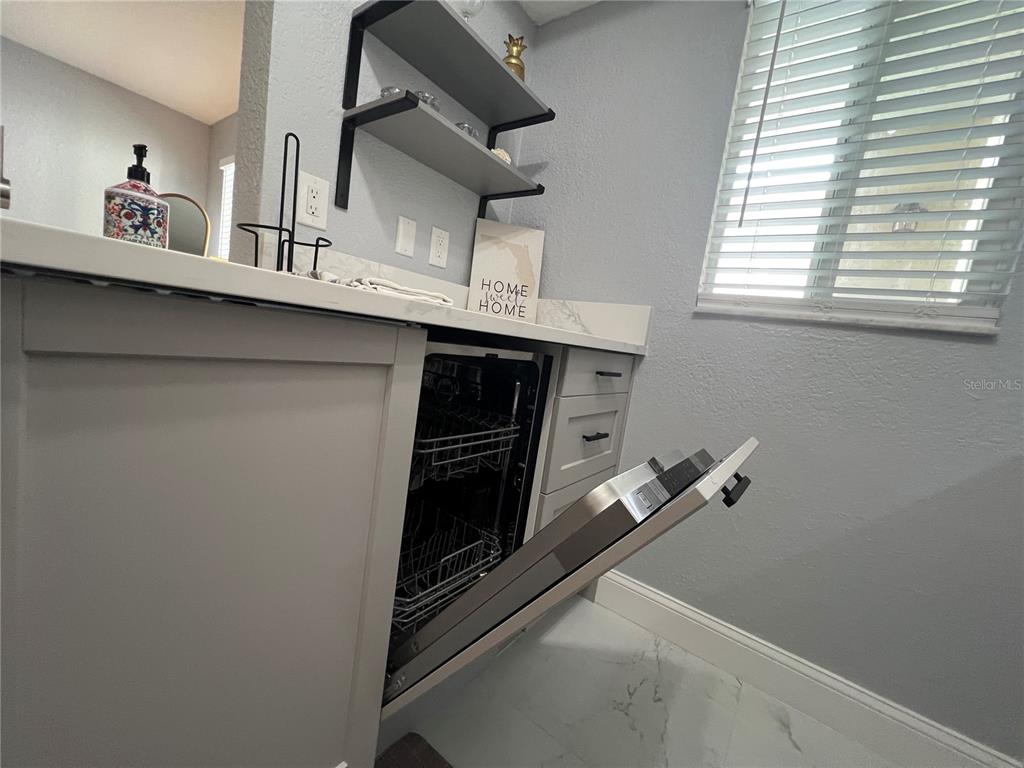 2704 2nd Street, Unit 7 Indian Rocks Beach, FL 33785 - Photo 19 of 32 a utility room with closet and mirror