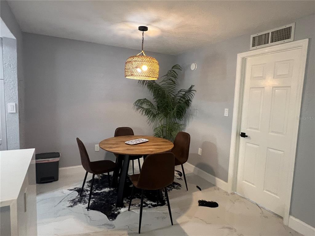 2704 2nd Street, Unit 7 Indian Rocks Beach, FL 33785 - Photo 20 of 32 a view of a dining room with a table and chairs