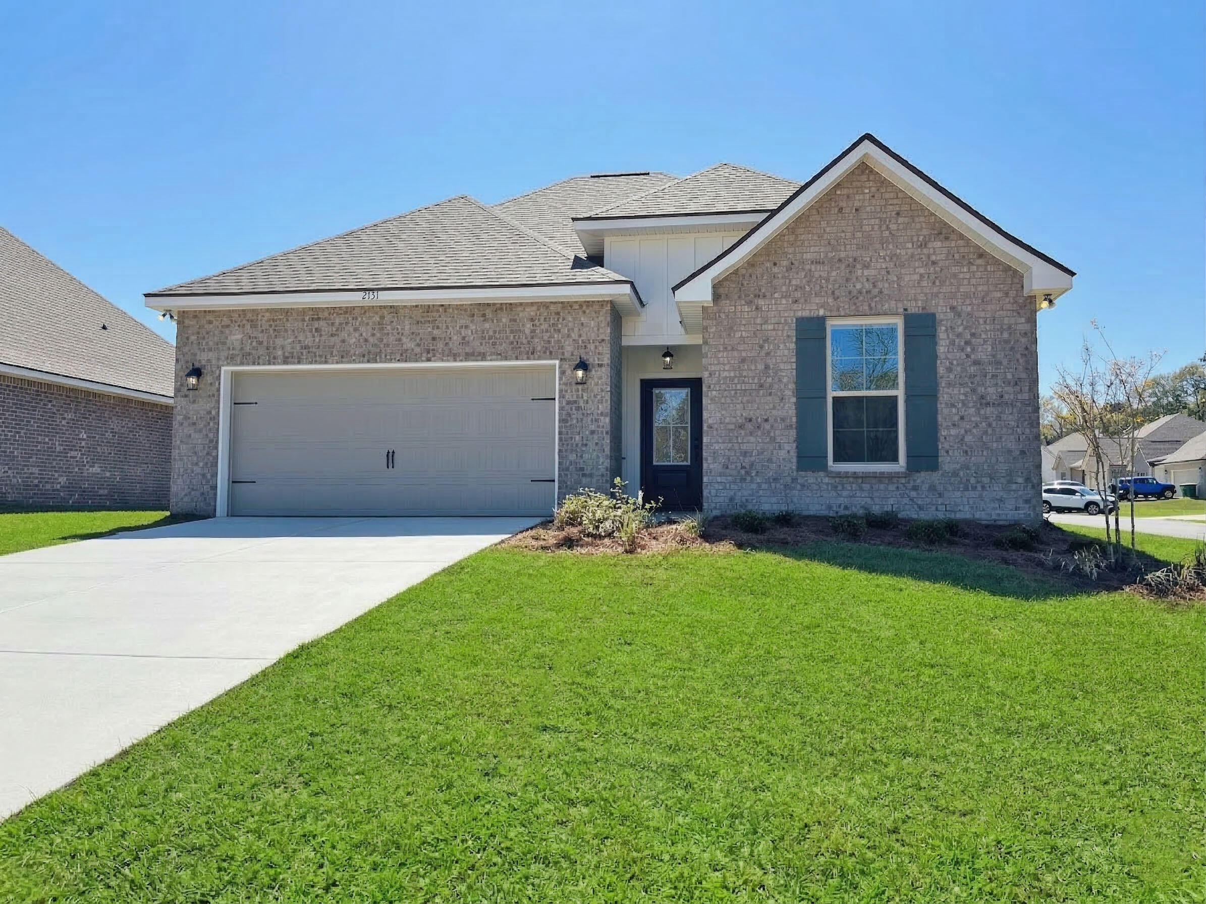 2731 Louis Circle Crestview, FL 32536 - Photo 1 of 17 a front view of a house with a garden and yard