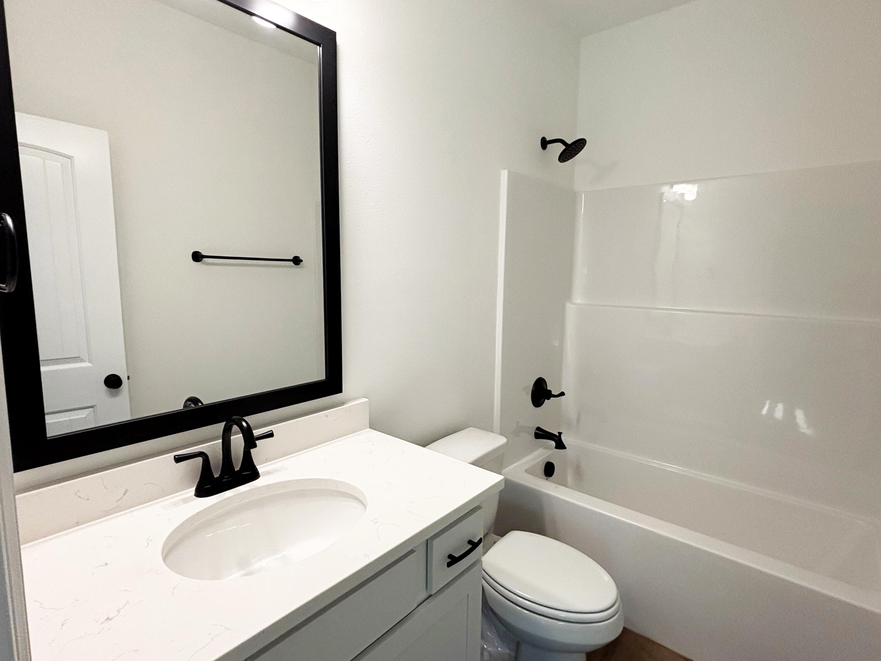 2731 Louis Circle Crestview, FL 32536 - Photo 12 of 17 a bathroom with a sink toilet vanity and shower