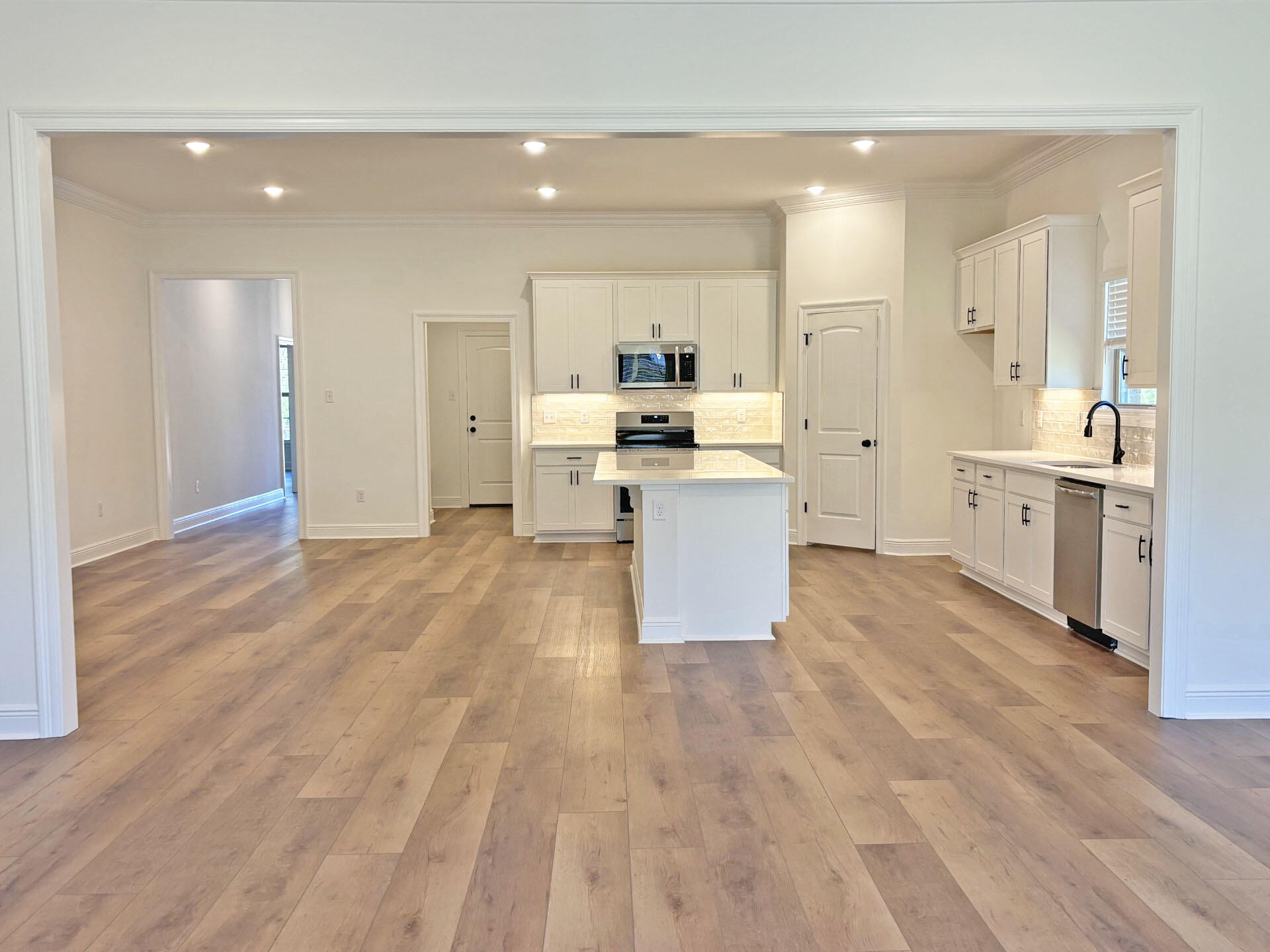 2731 Louis Circle Crestview, FL 32536 - Photo 7 of 17 a view of a kitchen with kitchen island a sink wooden floor and stainless steel appliances