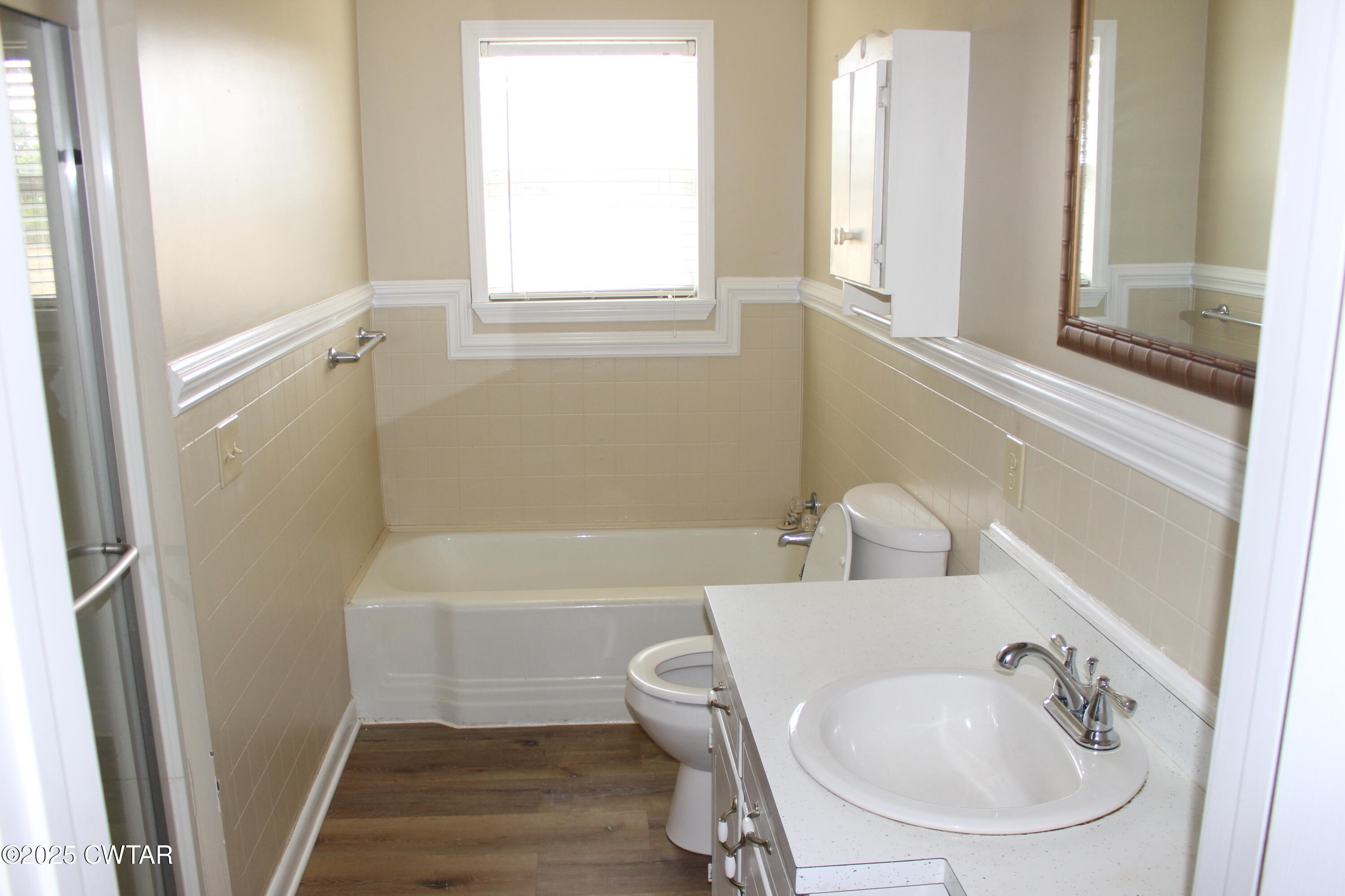 8860 Highway 138 Mercer, TN 38392 - Photo 14 of 23 a bathroom with a sink a window and a bathtub