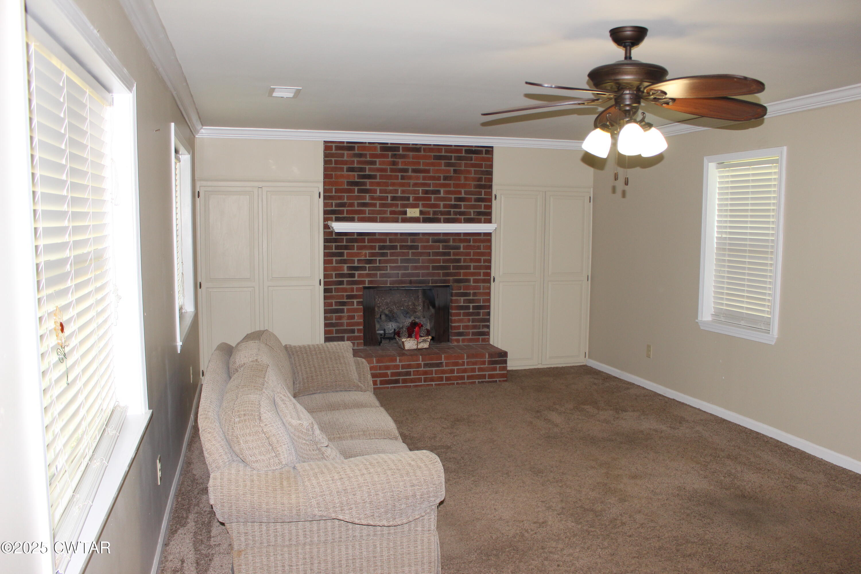 8860 Highway 138 Mercer, TN 38392 - Photo 6 of 23 a living room with furniture and a fireplace