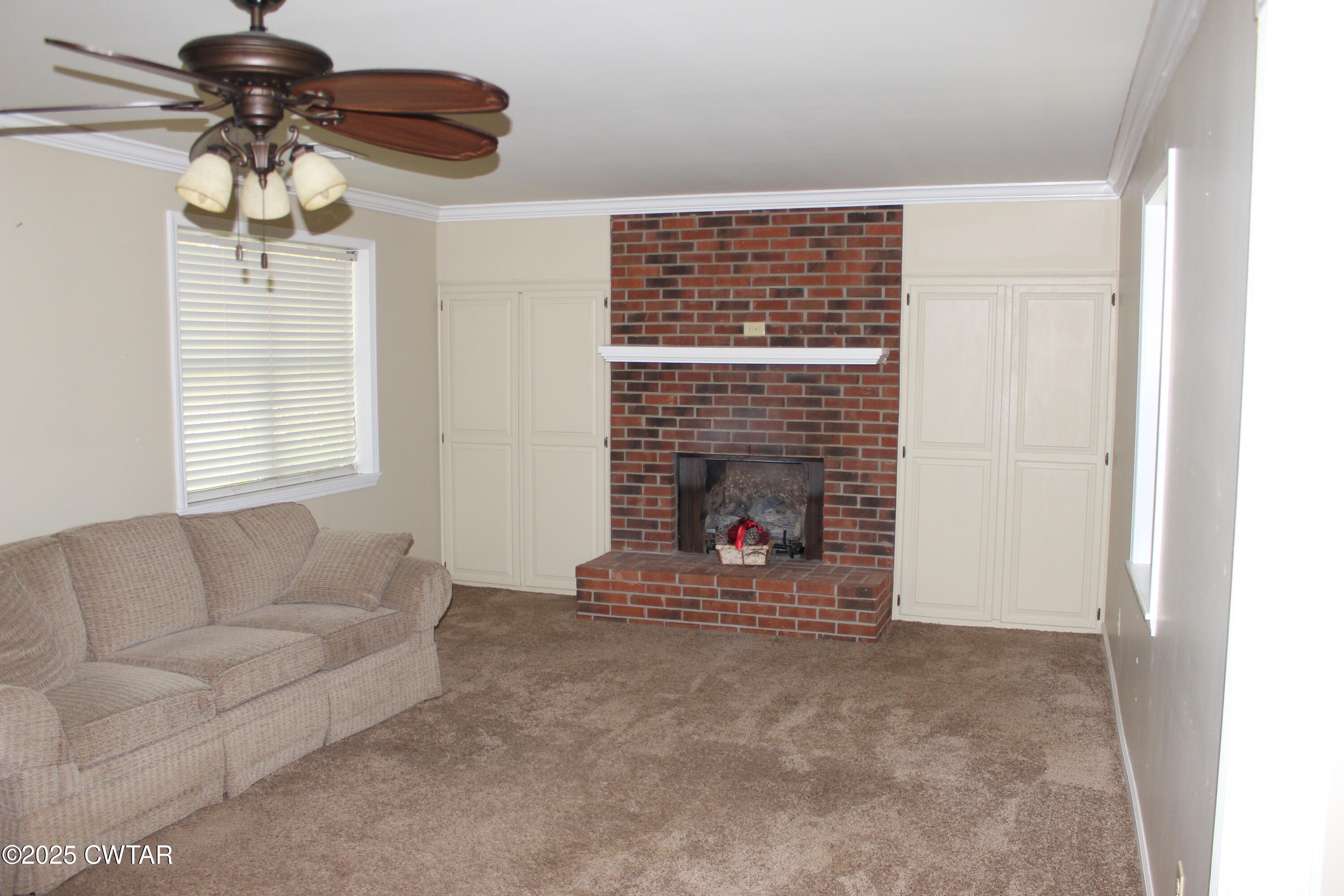 8860 Highway 138 Mercer, TN 38392 - Photo 7 of 23 a living room with furniture and a fireplace