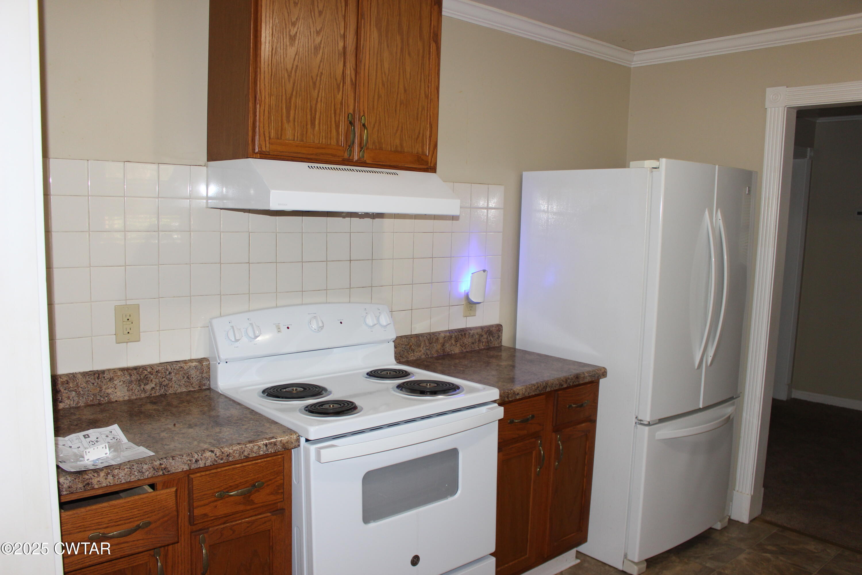 8860 Highway 138 Mercer, TN 38392 - Photo 9 of 23 a kitchen with a stove and a refrigerator