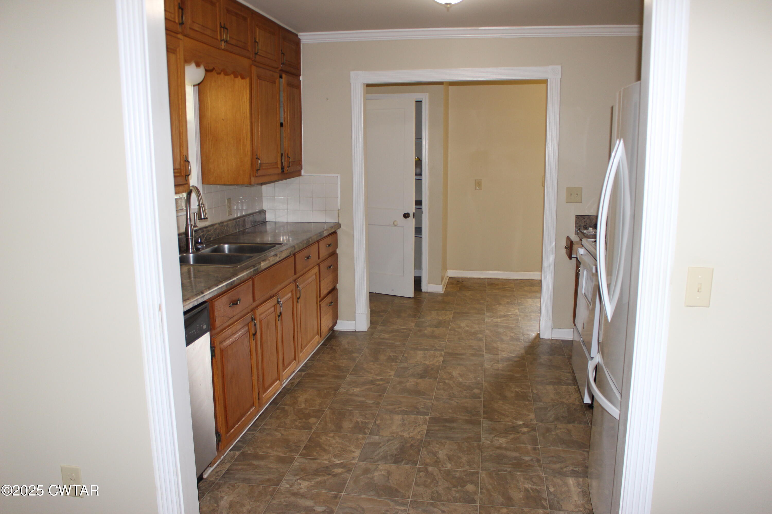 8860 Highway 138 Mercer, TN 38392 - Photo 10 of 23 a kitchen with a sink and a refrigerator