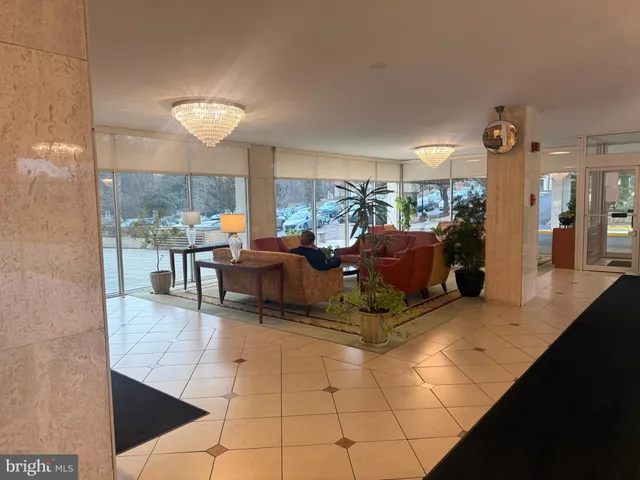 a living room with couch and large windows