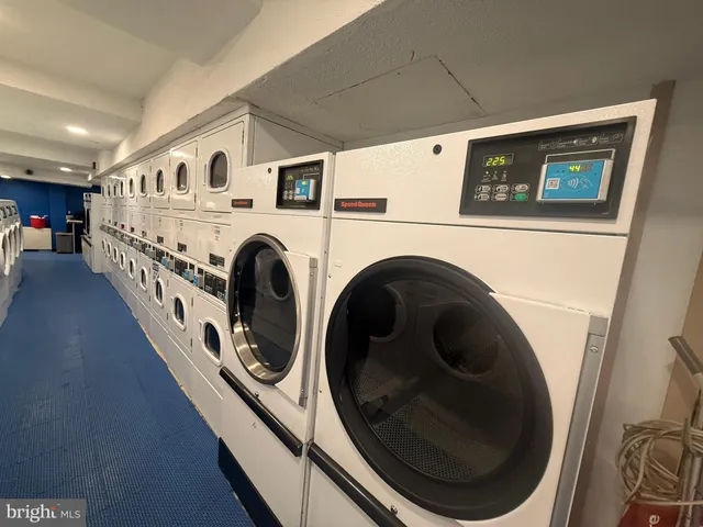 a view of a hallway with washer and dryer