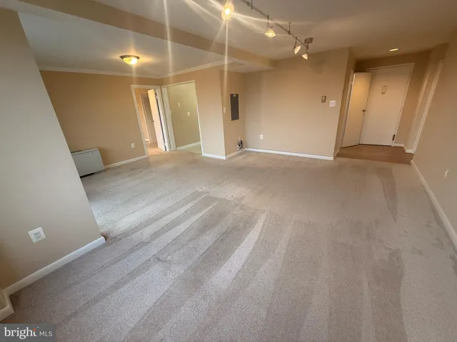 wooden floor in an empty room with a bathroom