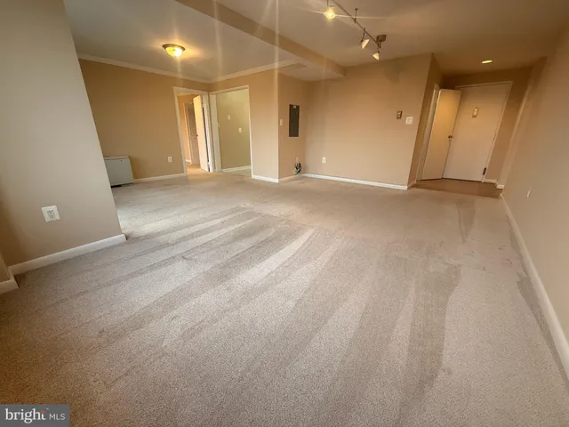 an empty room with projector and entrance