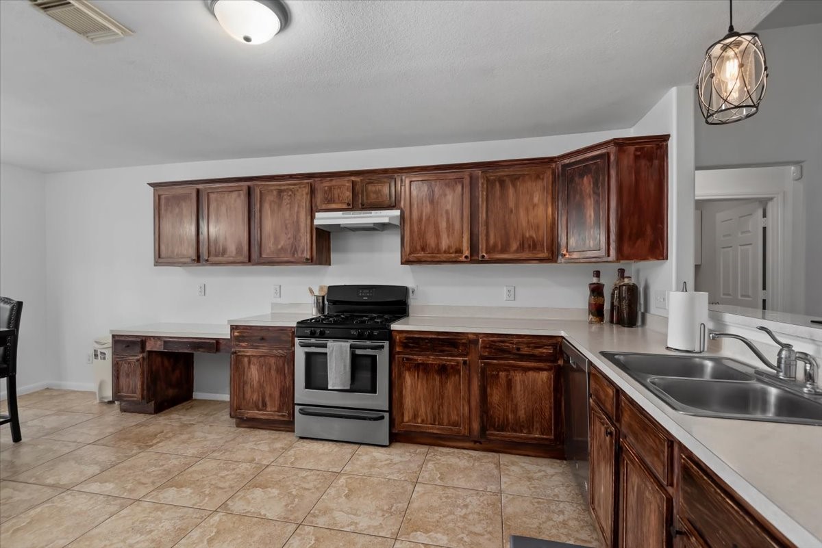 22711 Tree House Lane Spring, TX 77373 - Photo 11 of 28 a kitchen with stainless steel appliances granite countertop a sink stove and cabinets